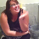 A fat British girl is seen sitting on a toilet while shitting. No pooping sounds can be heard.